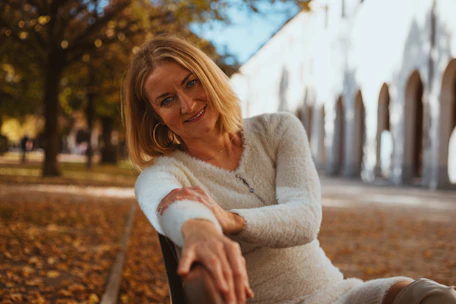 A woman sitting on a bench in a park