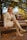 A woman sitting on a bench in a park