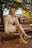 A woman sitting on a bench in a park