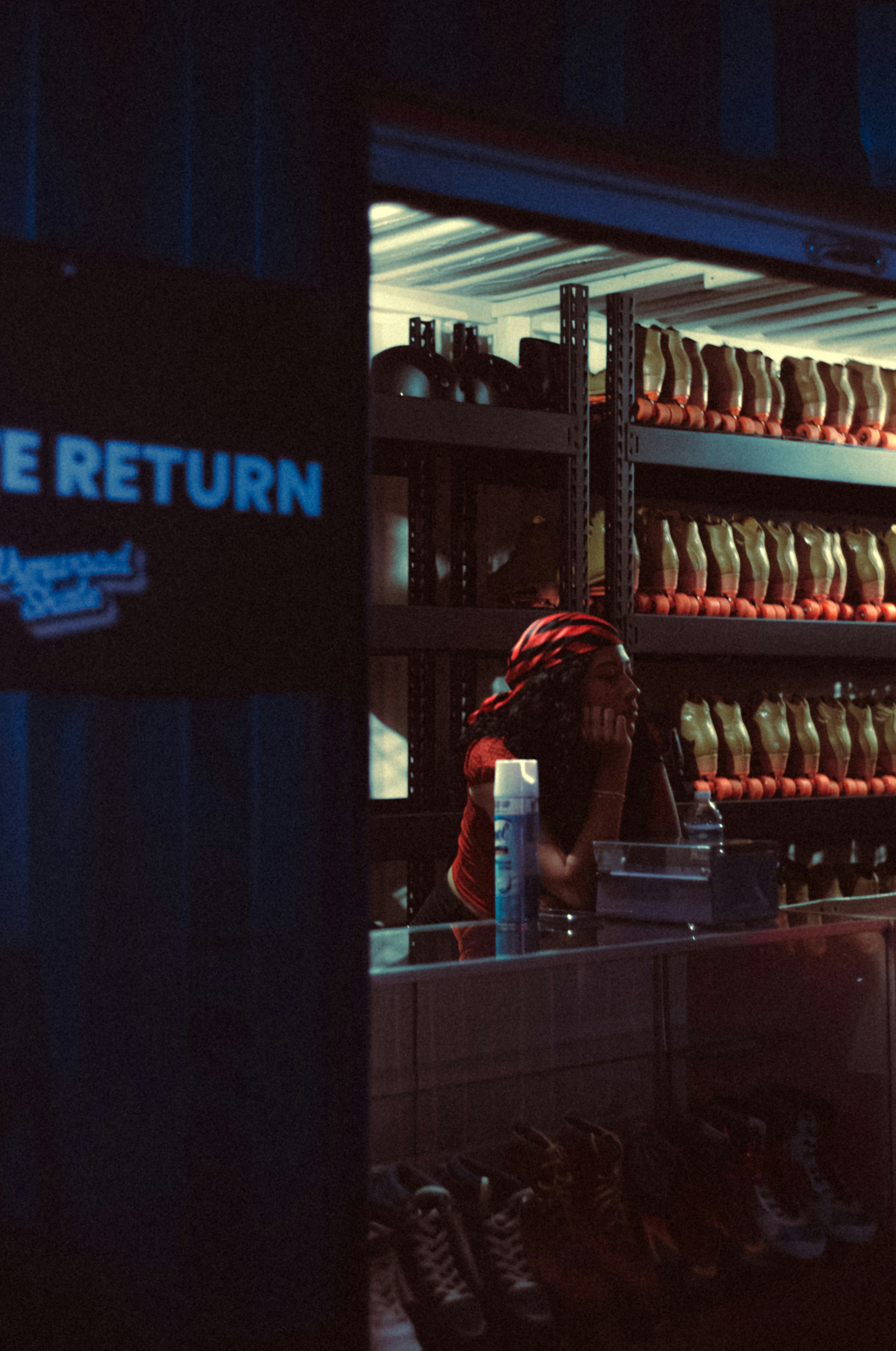 A person standing in front of a store filled with shoes