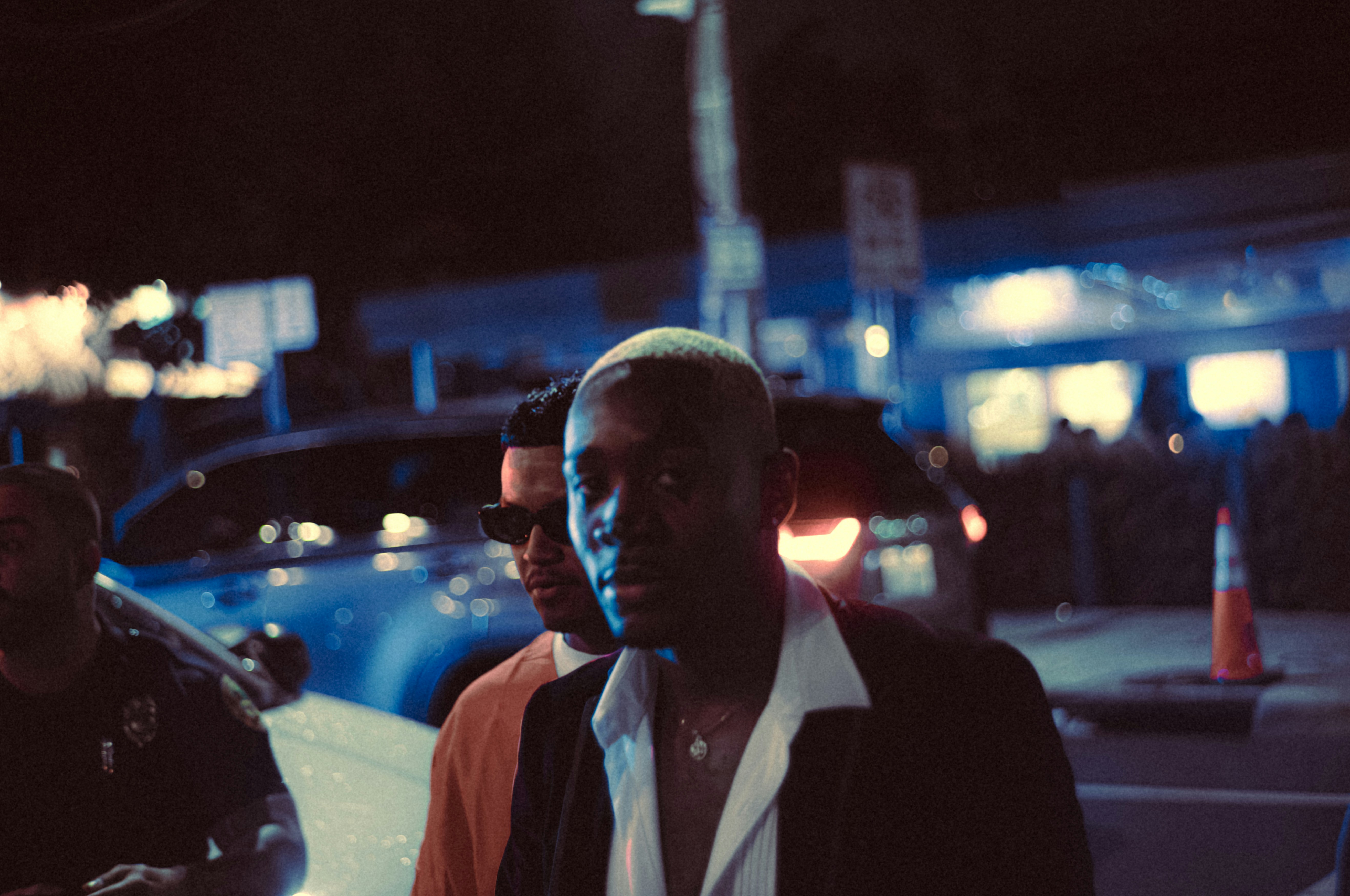 A group of men standing next to each other on a street