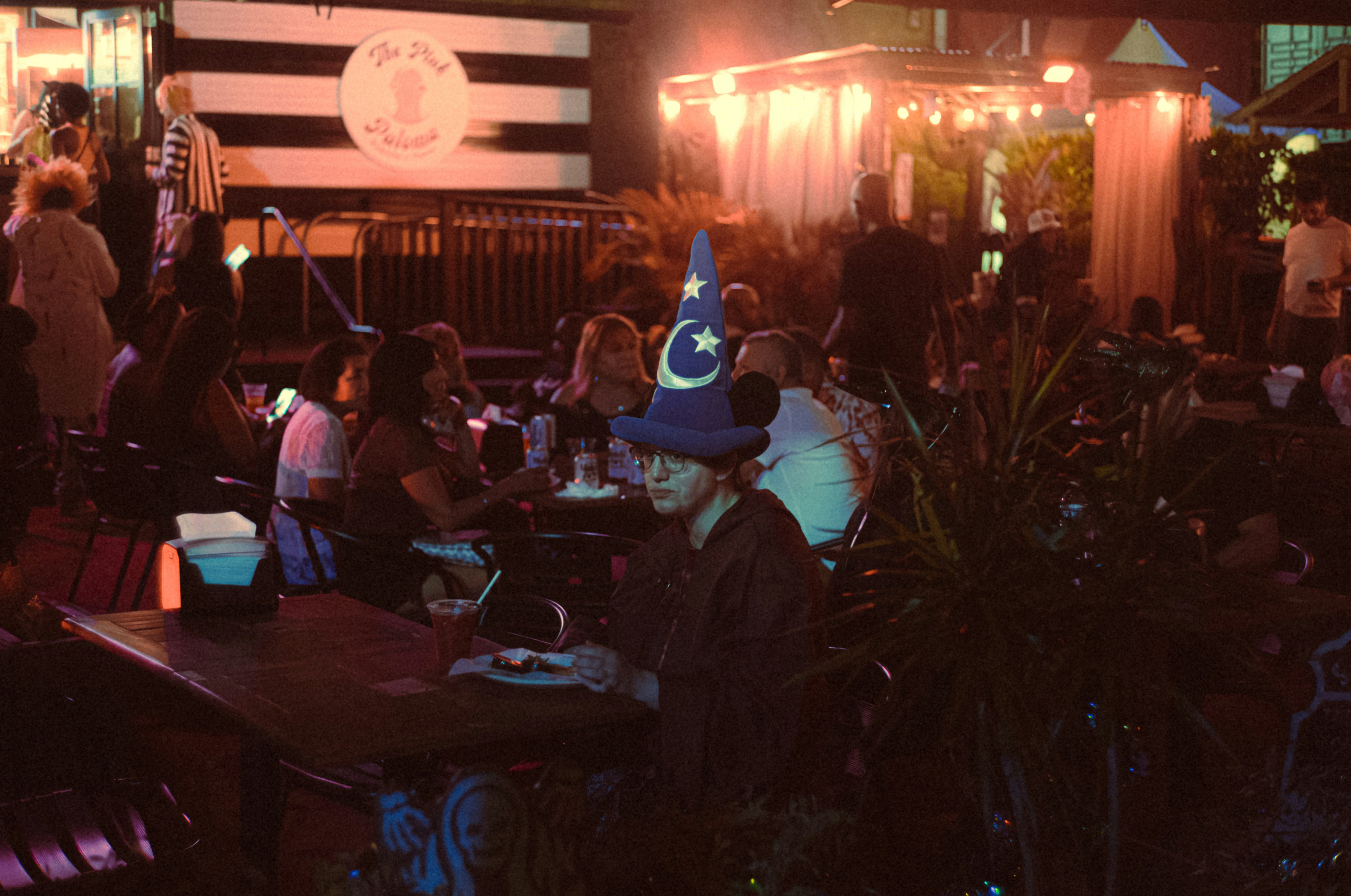 A group of people sitting at tables in a restaurant