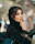 A woman in a black hijab sitting on a car