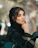 A woman in a black hijab sitting on a car