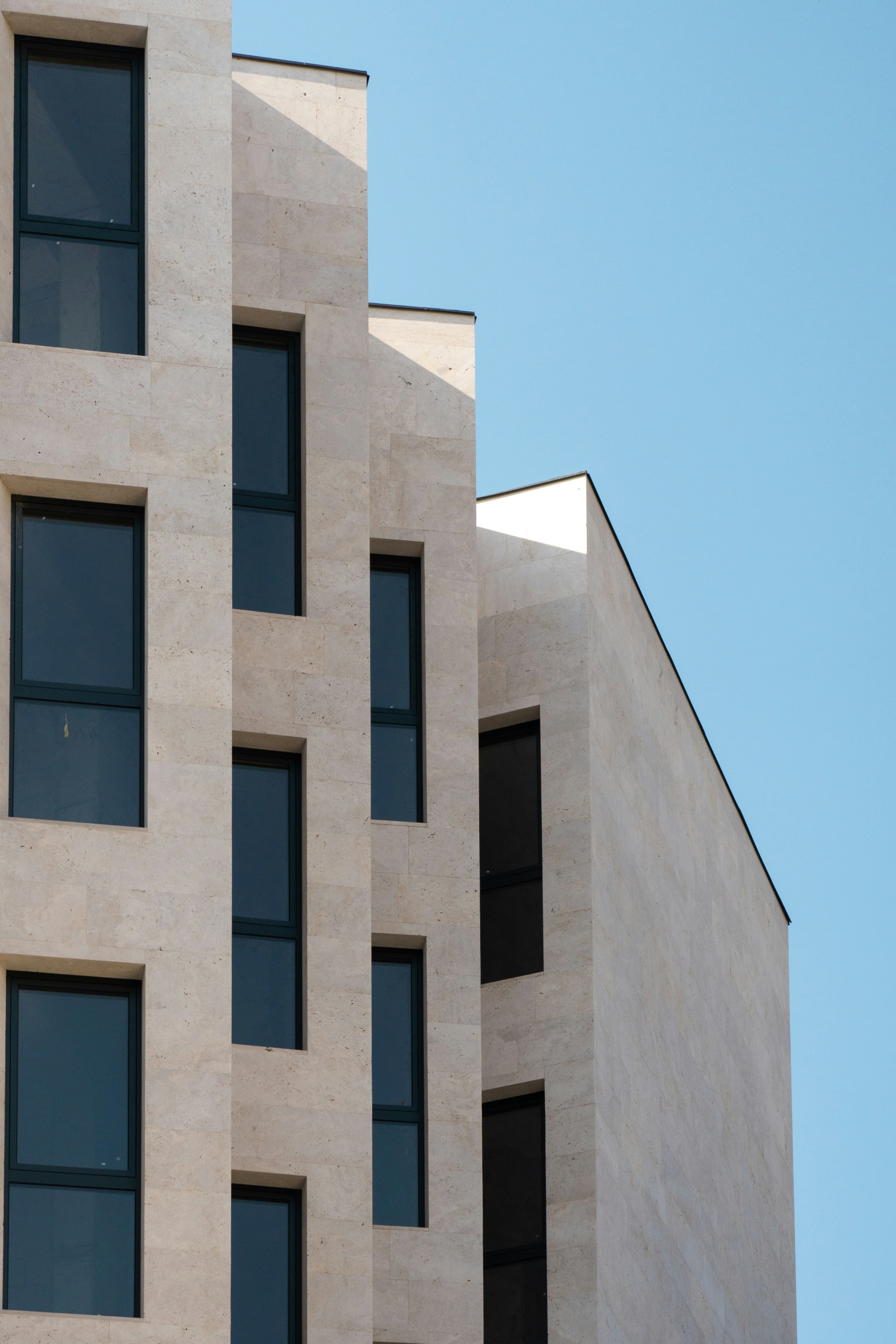 A tall white building with lots of windows