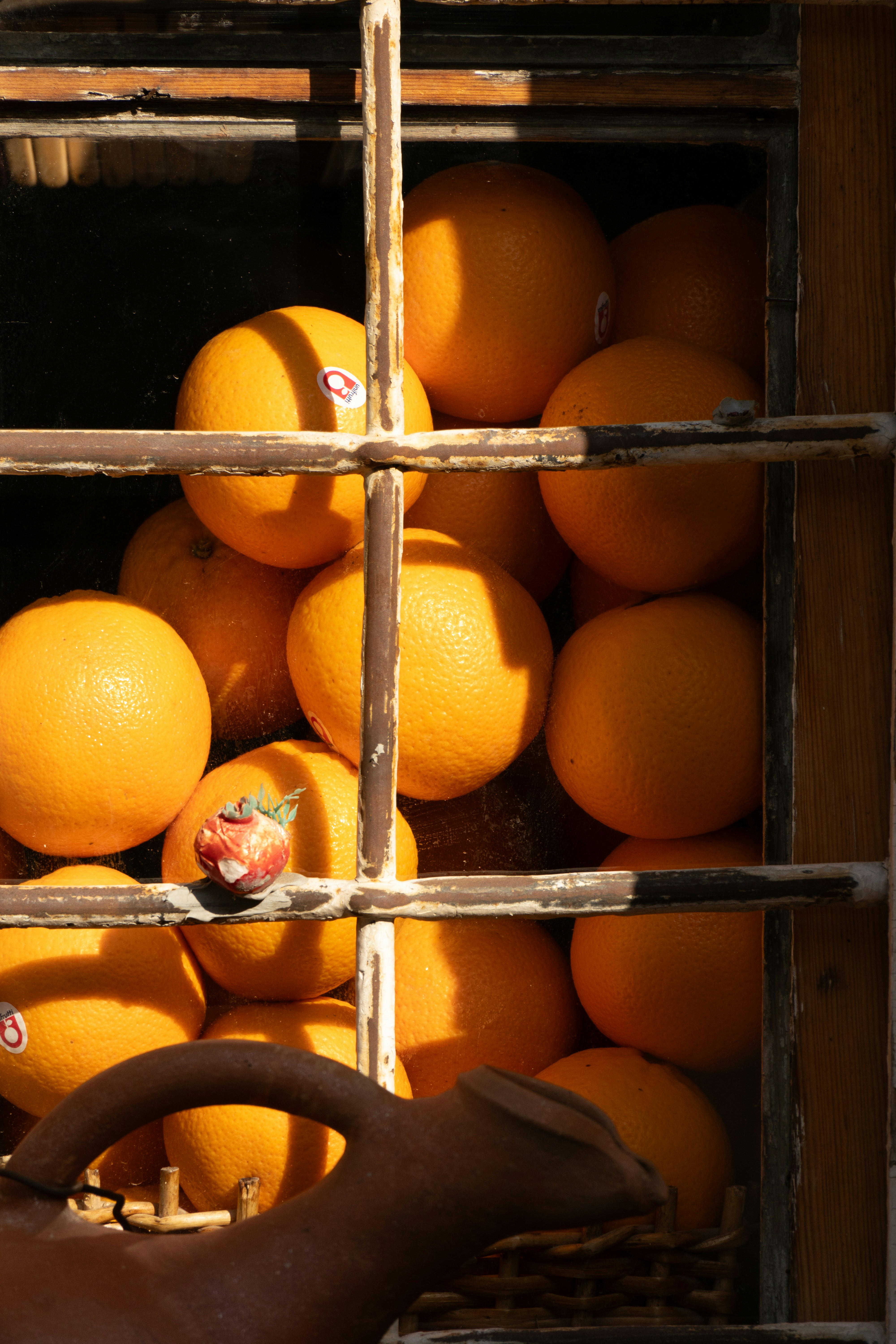 A person holding a basket full of oranges