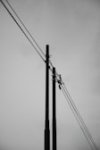 A black and white photo of power lines and telephone poles