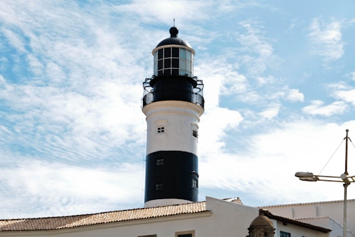 A black and white lighthouse on top of a building
