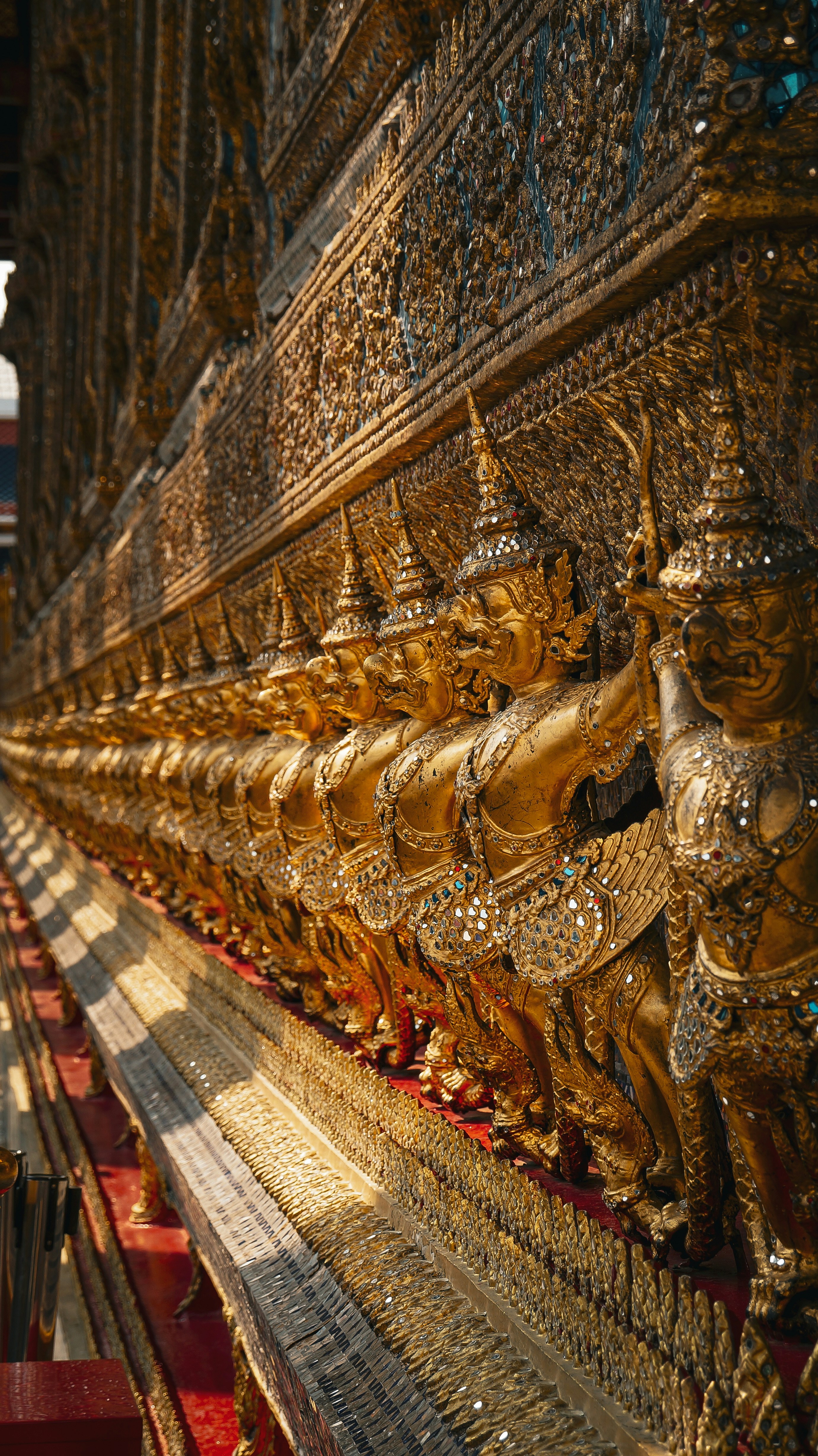 A large golden statue sitting on the side of a building