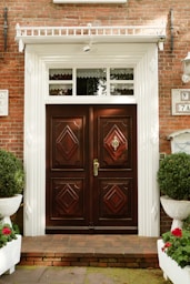 A brick building with two large wooden doors