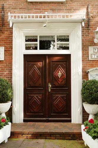 A brick building with two large wooden doors