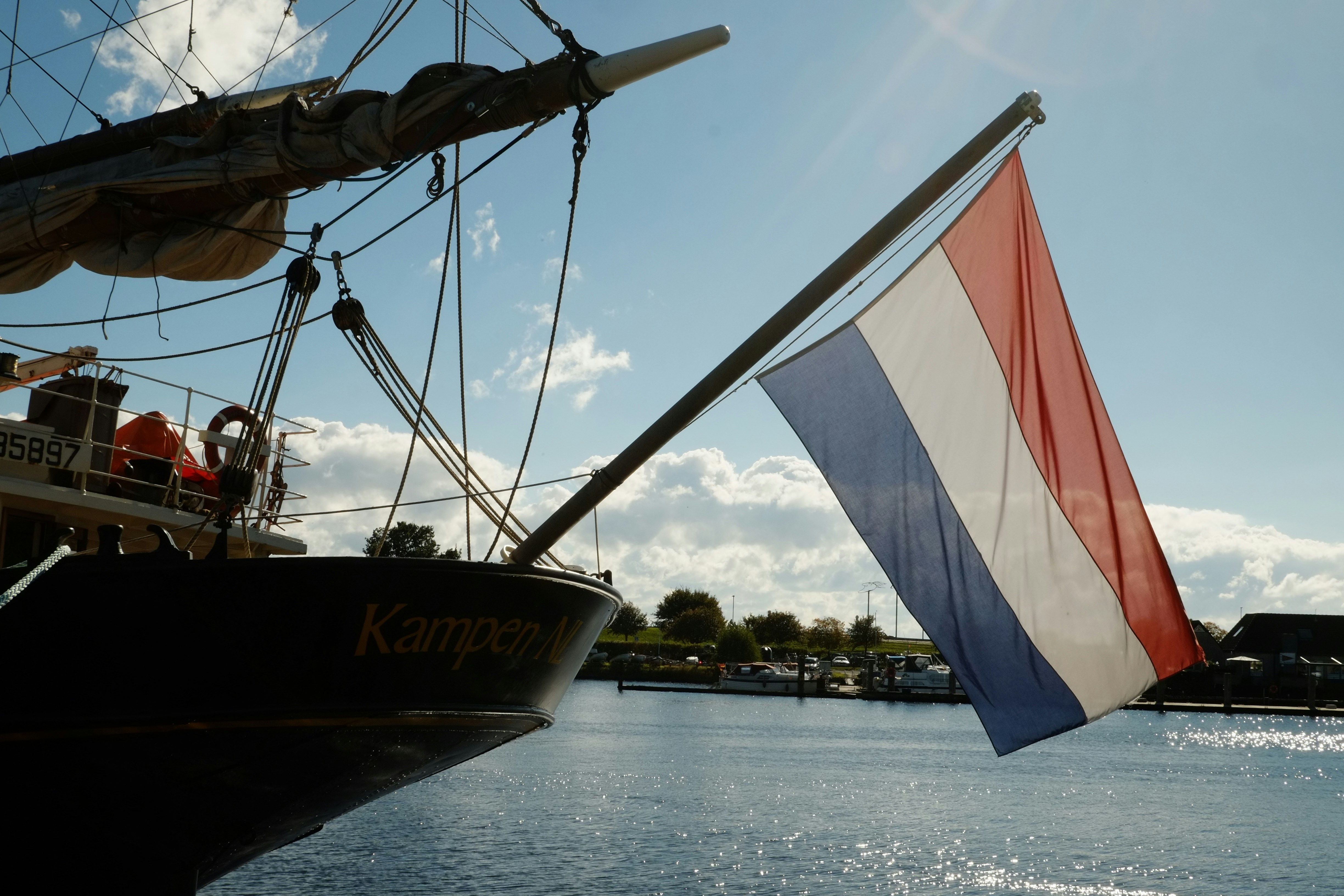 A boat with a flag on the side of it