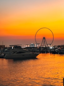 A ferris wheel is in the distance as the sun sets