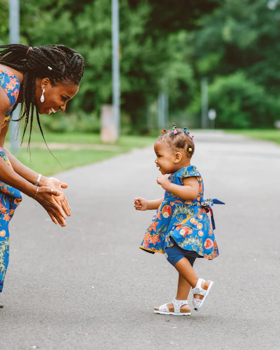A woman and a little girl playing with a ball