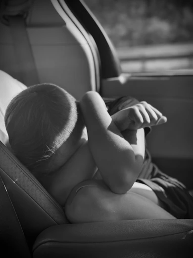 A small child is sitting in a car seat