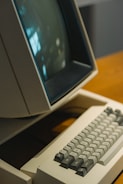 An old computer sitting on top of a wooden desk