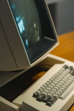 An old computer sitting on top of a wooden desk