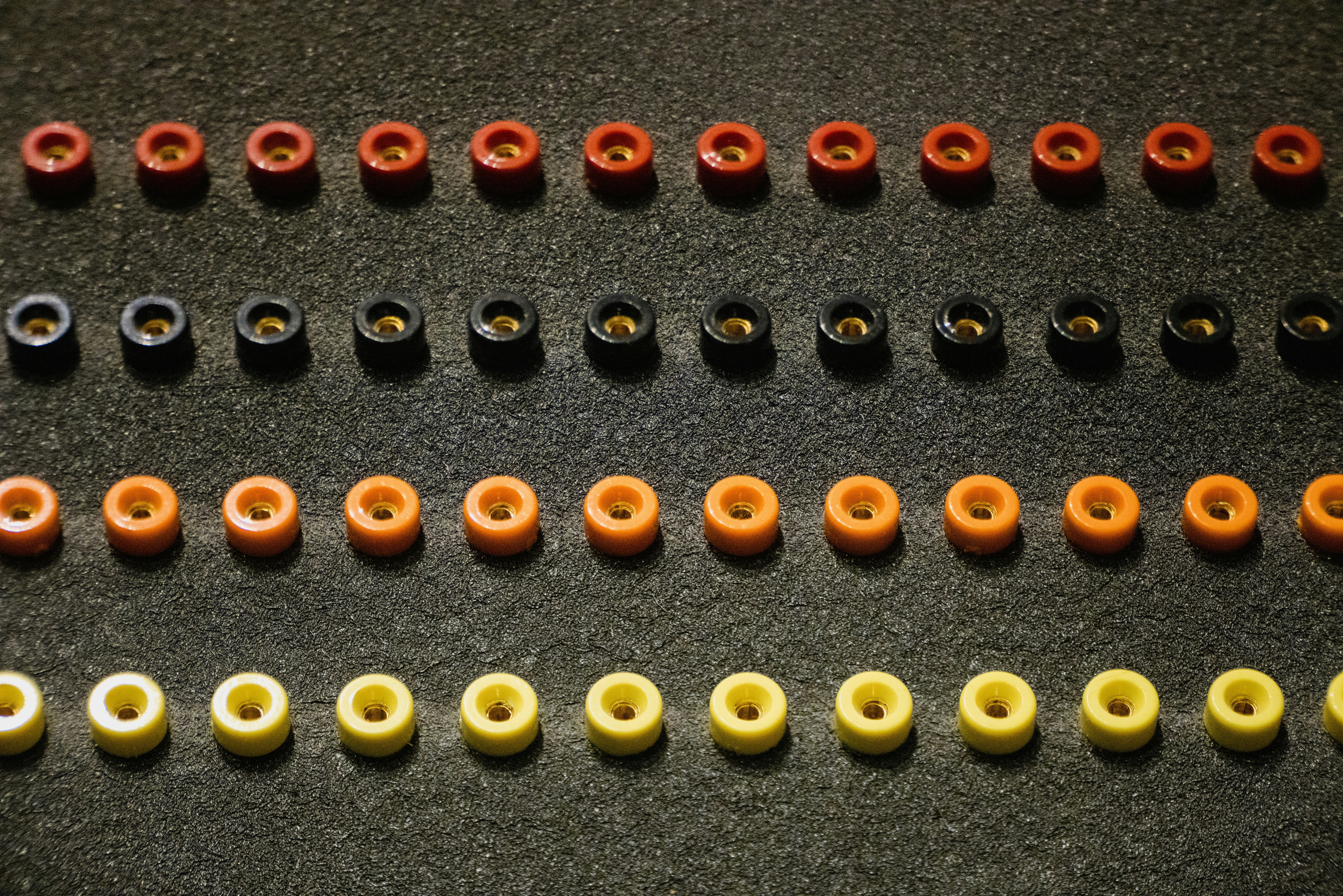 A group of different colored beads sitting on top of a table photo ...