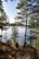 A person walking on a trail near a lake