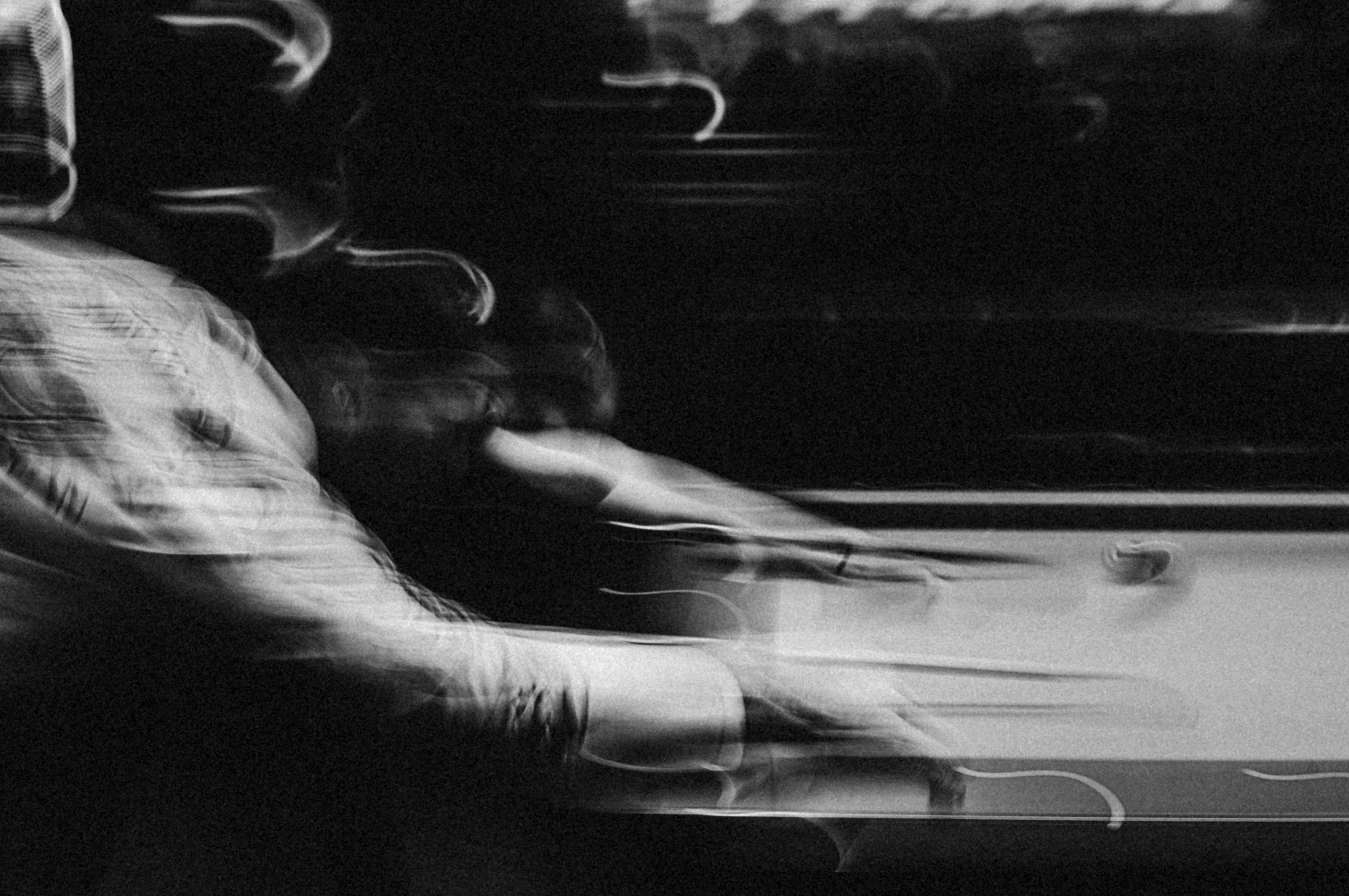 A blurry photo of a man sitting on a train