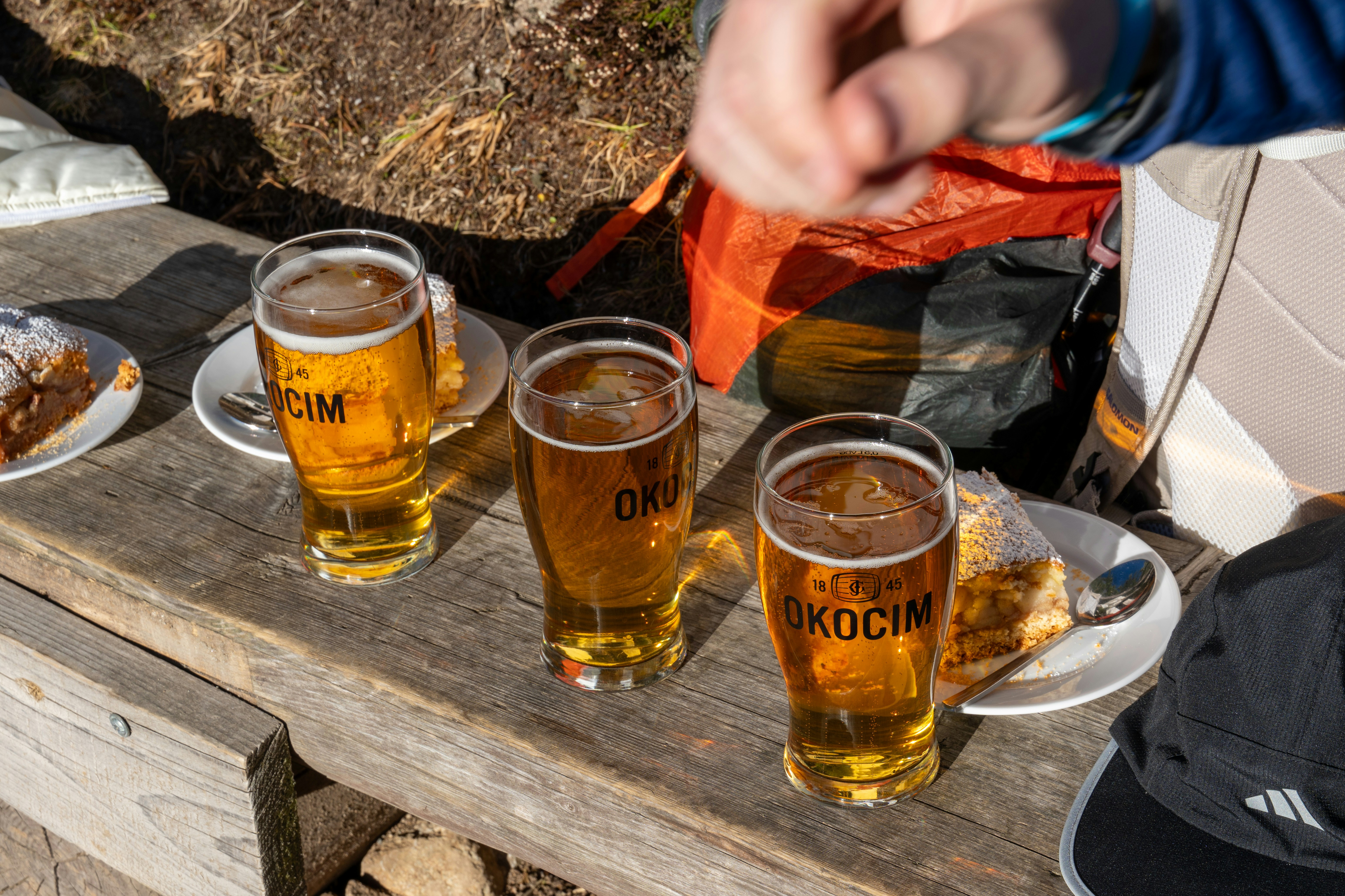 Glasses of beer on a weathered outdoor table