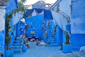 A narrow alley with blue walls and steps