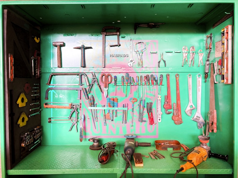 A green cabinet filled with lots of tools