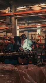 Welders working on a machine in a factory