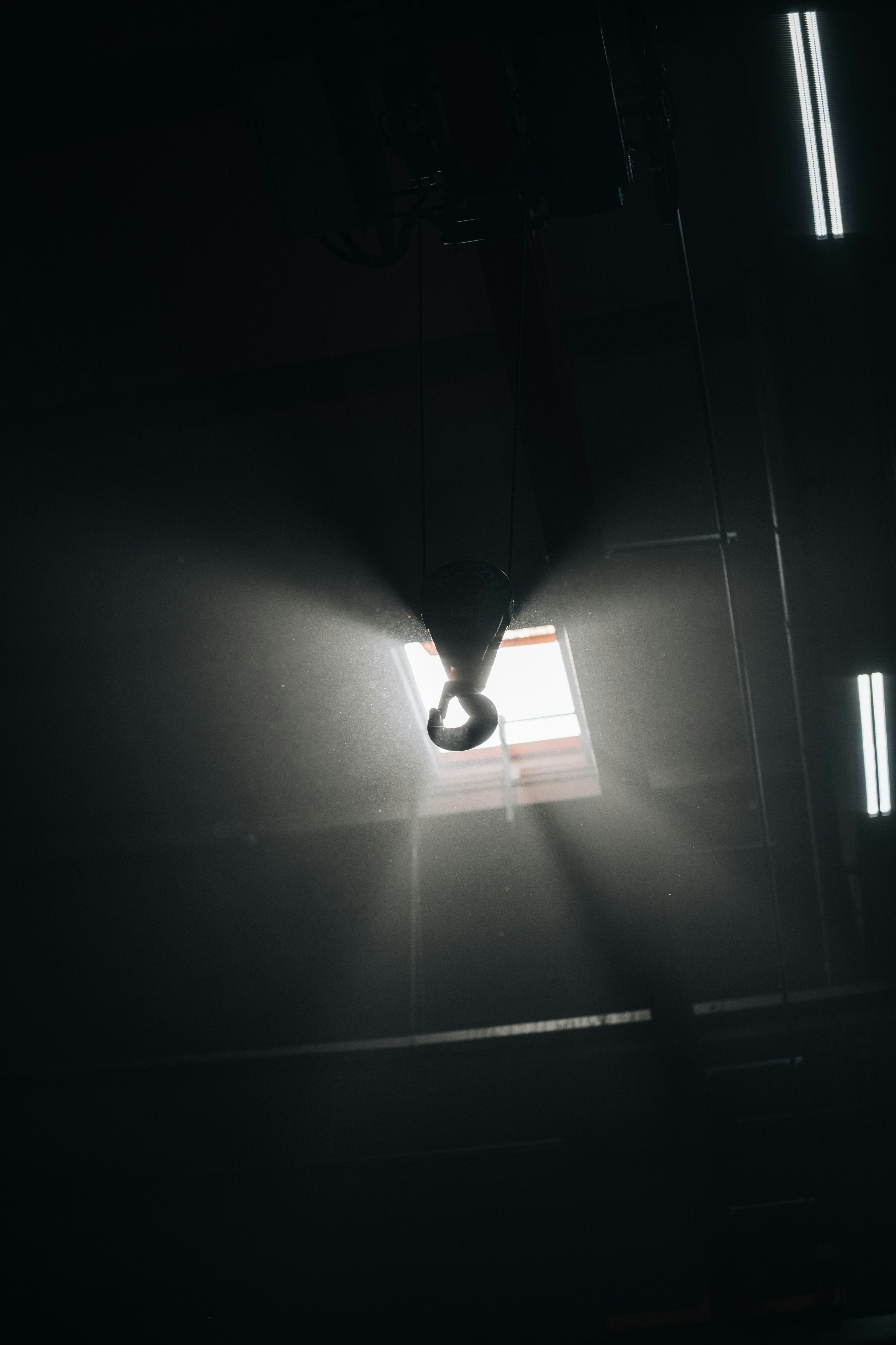 A dark room with a light coming through the window