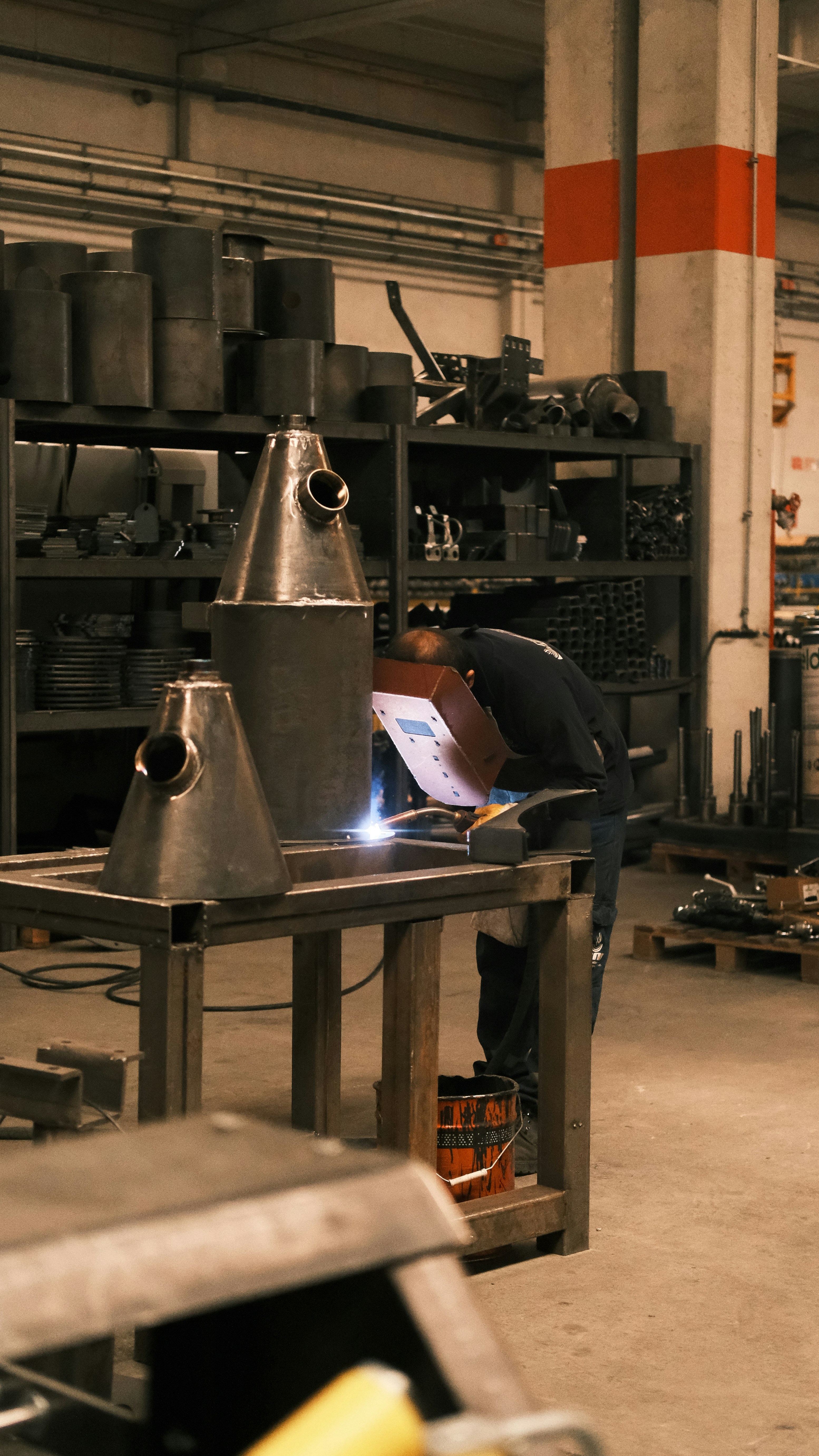 A man working on a piece of equipment in a factory