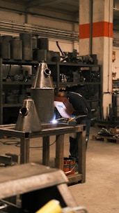A man working on a piece of equipment in a factory