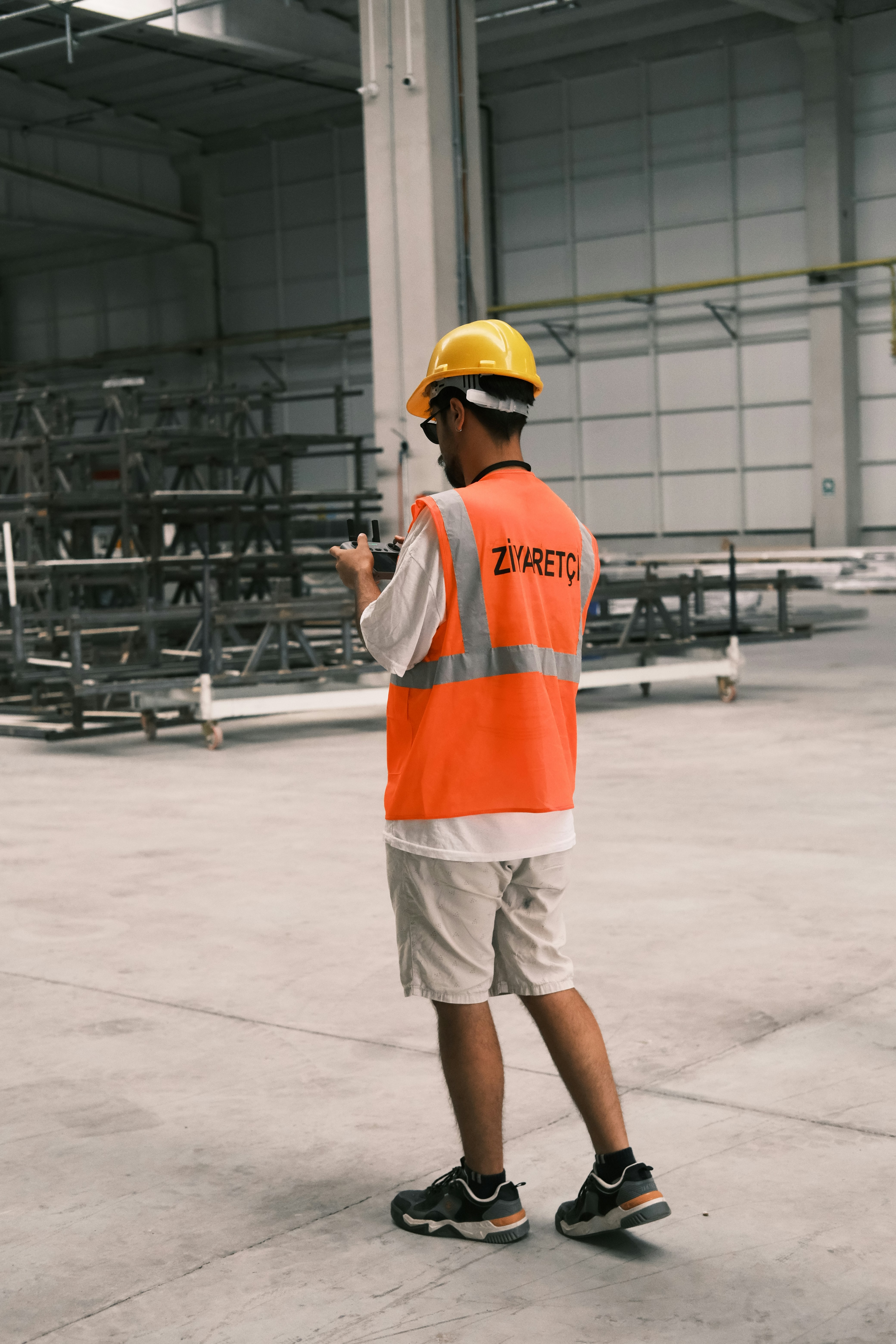 A man wearing a safety vest and a hard hat