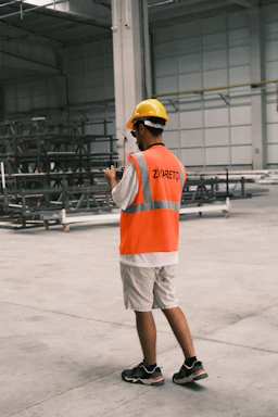 A man wearing a safety vest and a hard hat