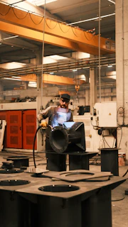 A man working on a machine in a factory