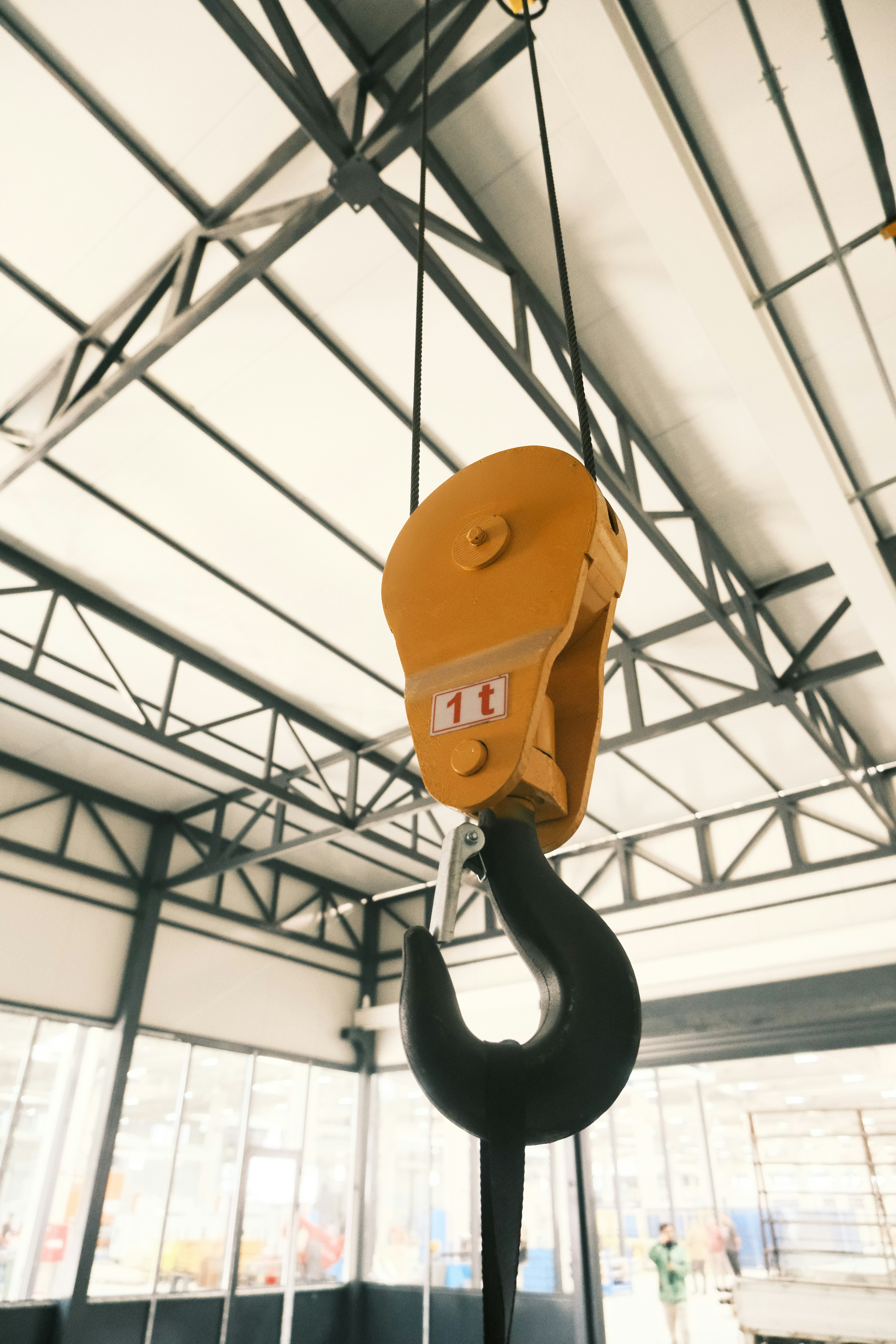 A crane lifting a piece of equipment in a warehouse
