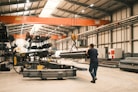 A man is walking through a large warehouse