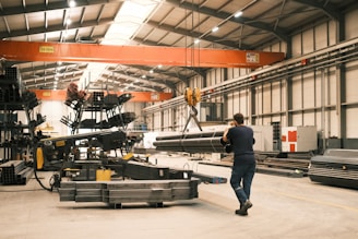 A man is walking through a large warehouse