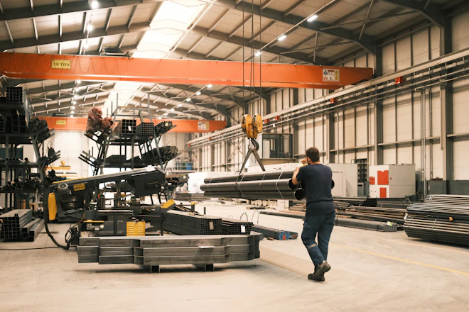 A man is walking through a large warehouse