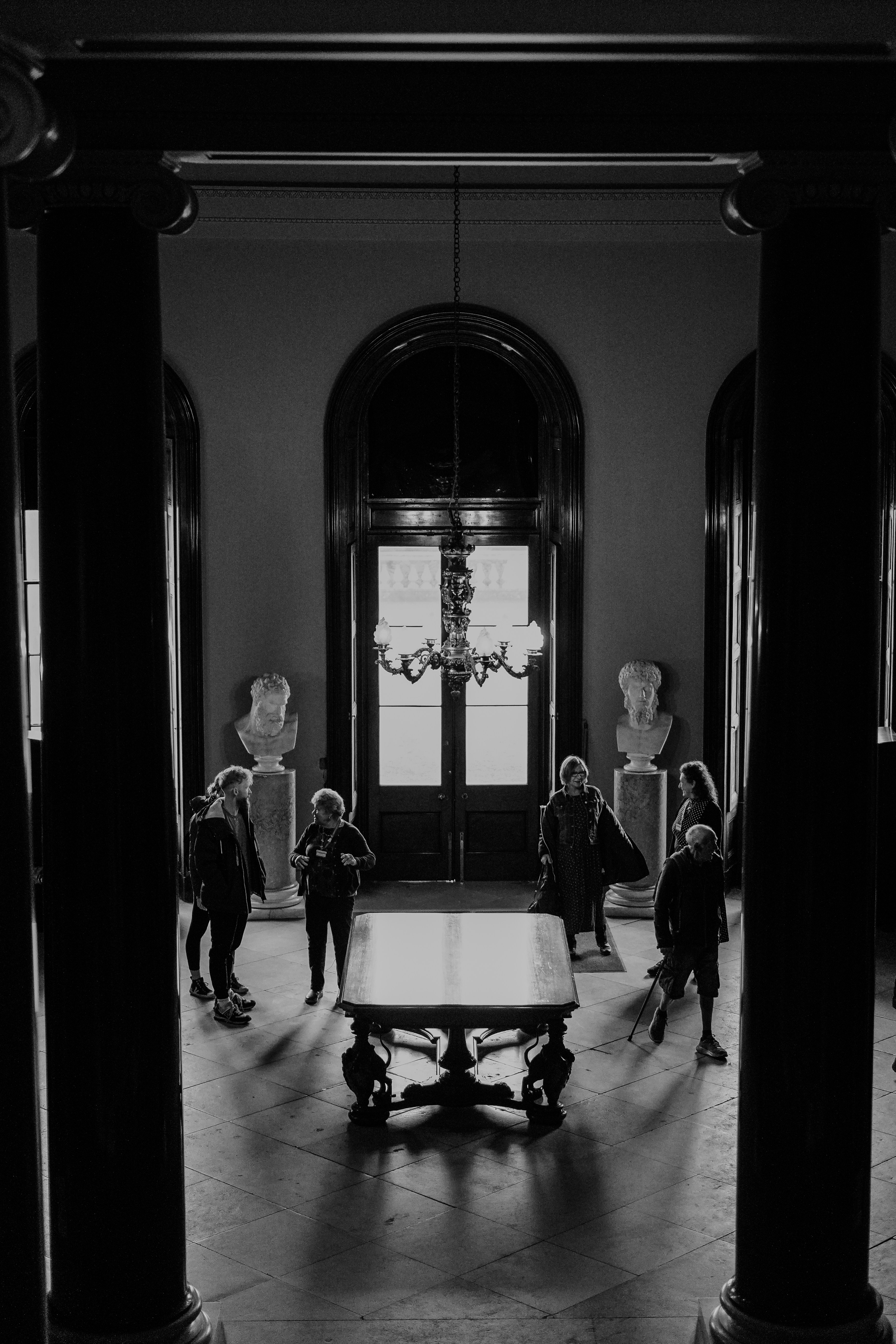 A group of people standing around a table in a room