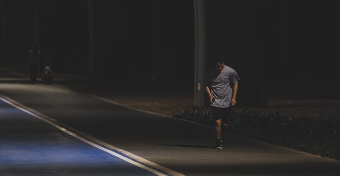 A man walking down a street at night
