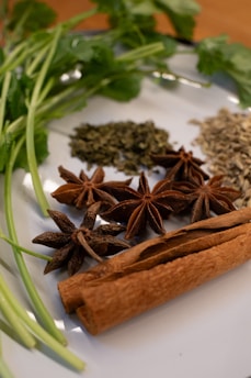 A white plate topped with spices and herbs