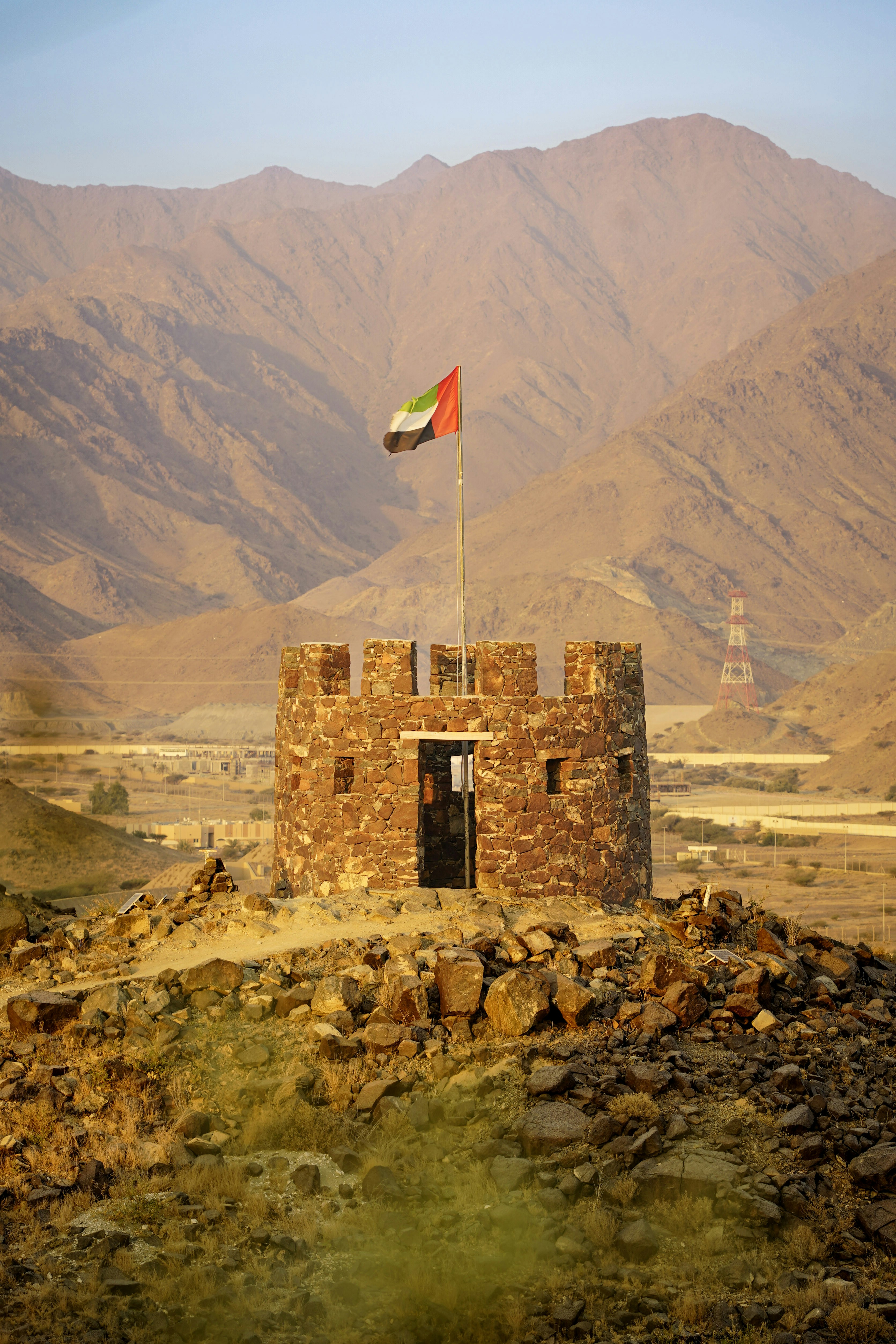 A small tower with a flag on top of it