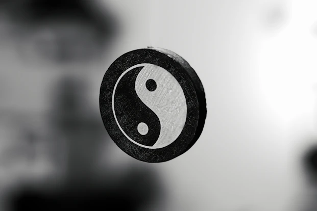 Minimal golden Bagua symbol on dark background, representing balance and ancient eastern wisdom