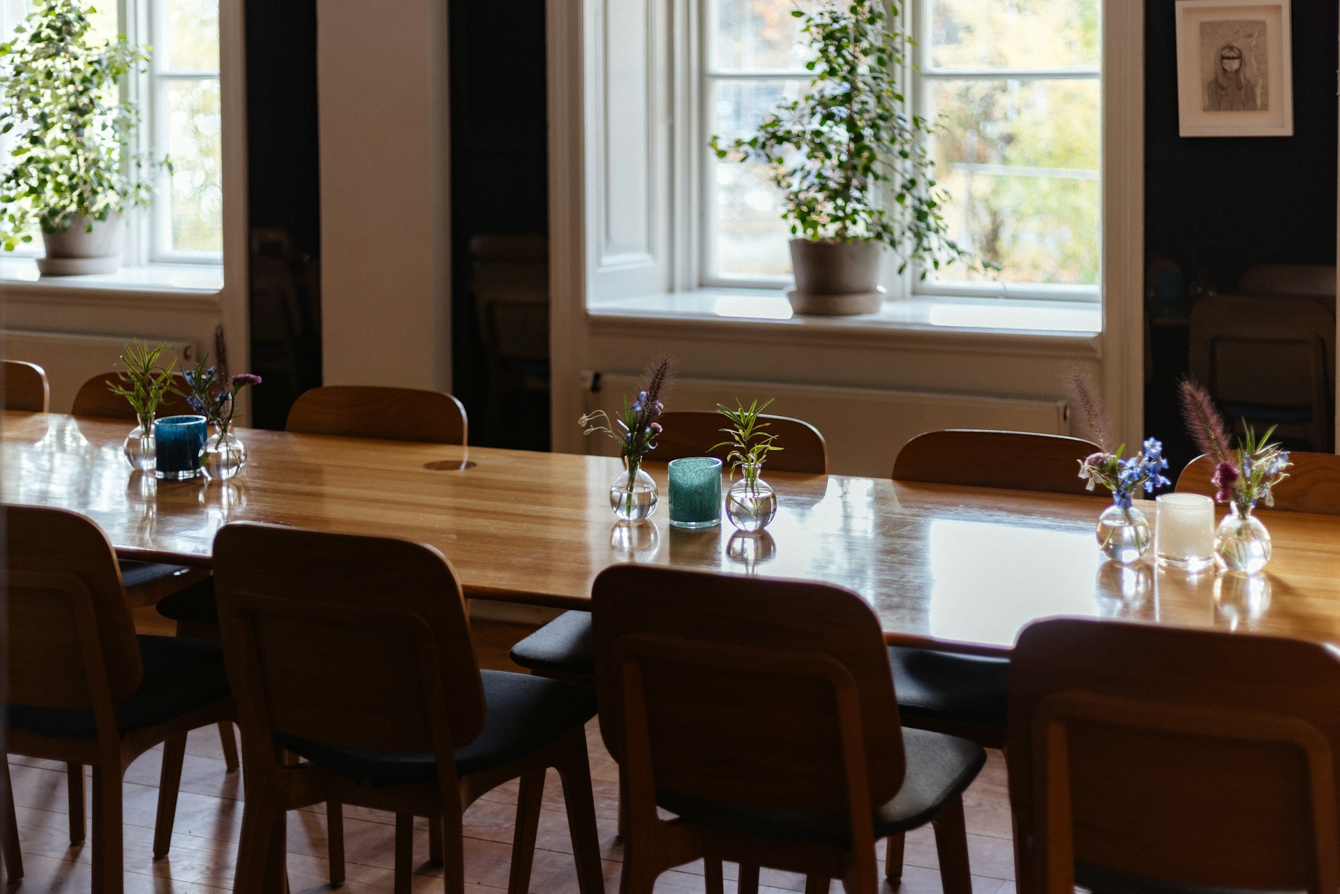 A long table with a bunch of chairs around it