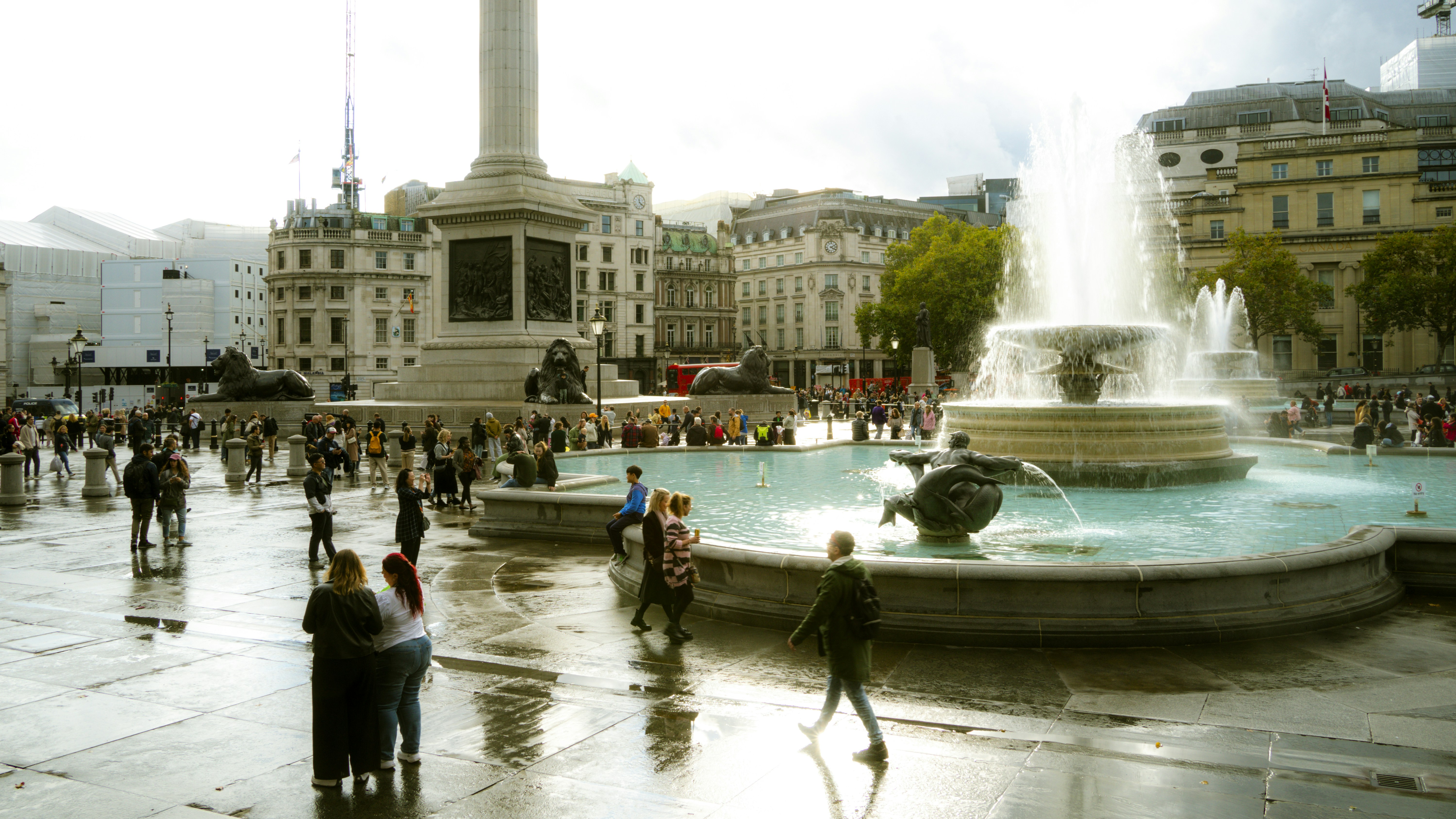 A group of people standing around a fountain
