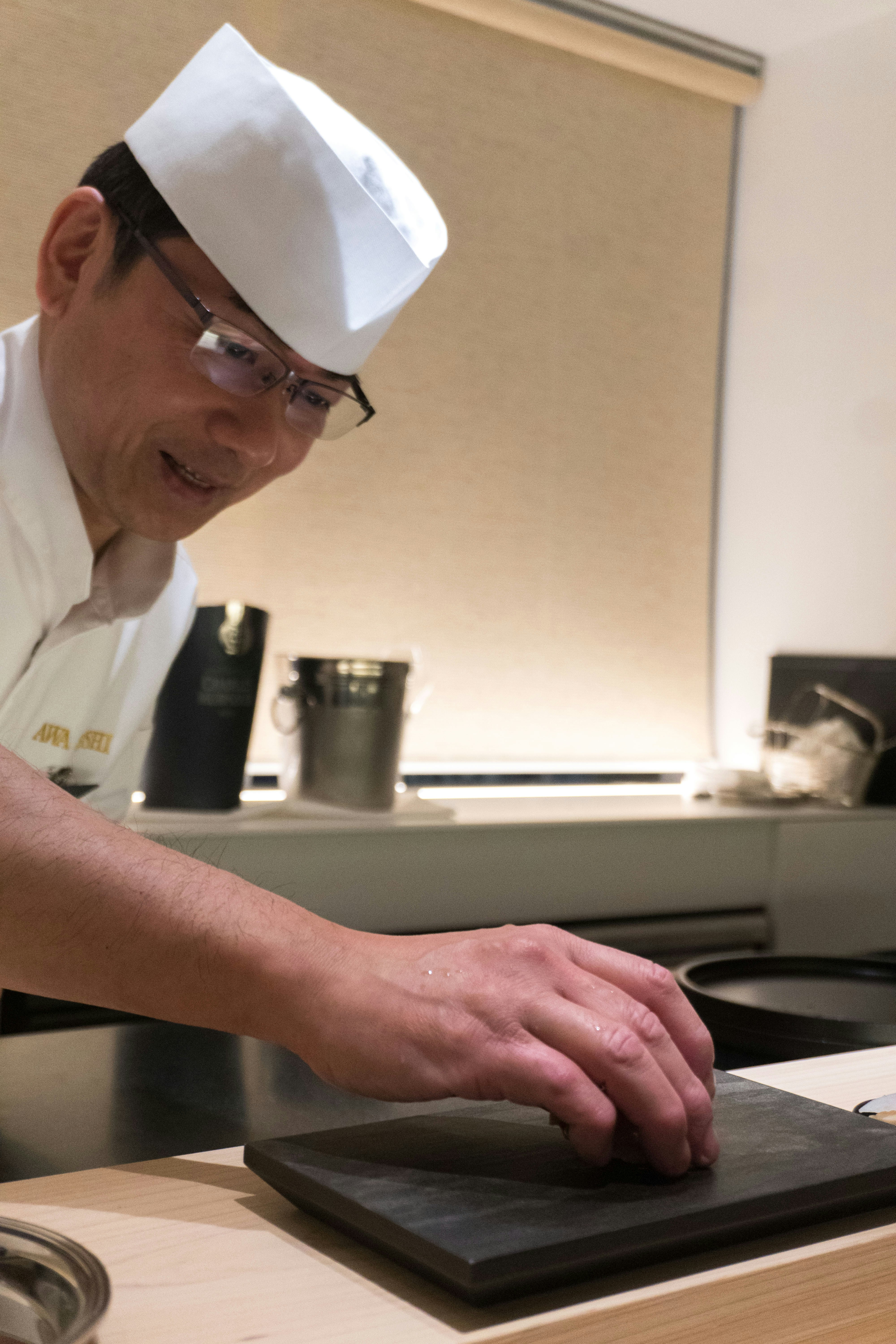 A man in a chef's hat working on a laptop