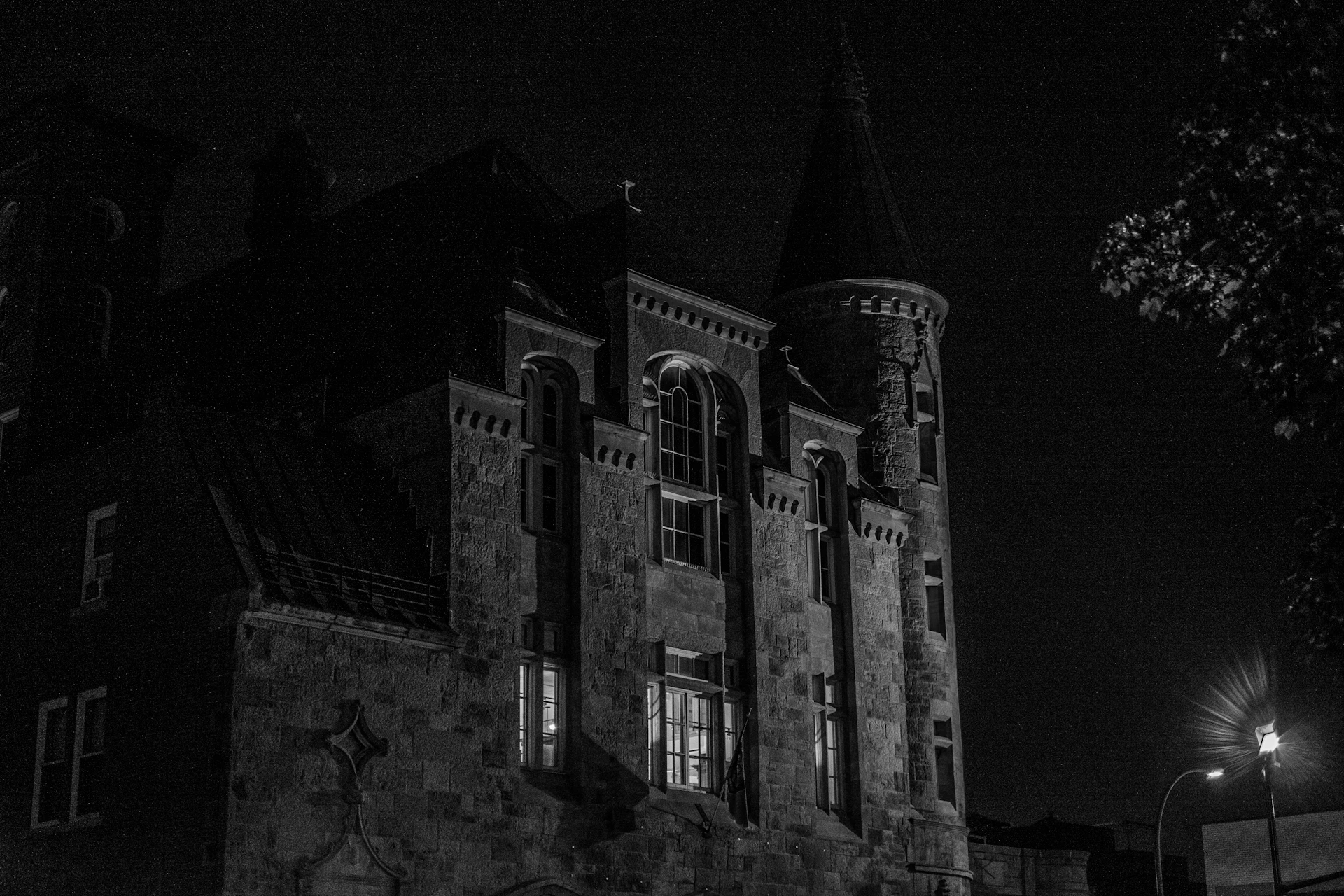 A black and white photo of a building at night