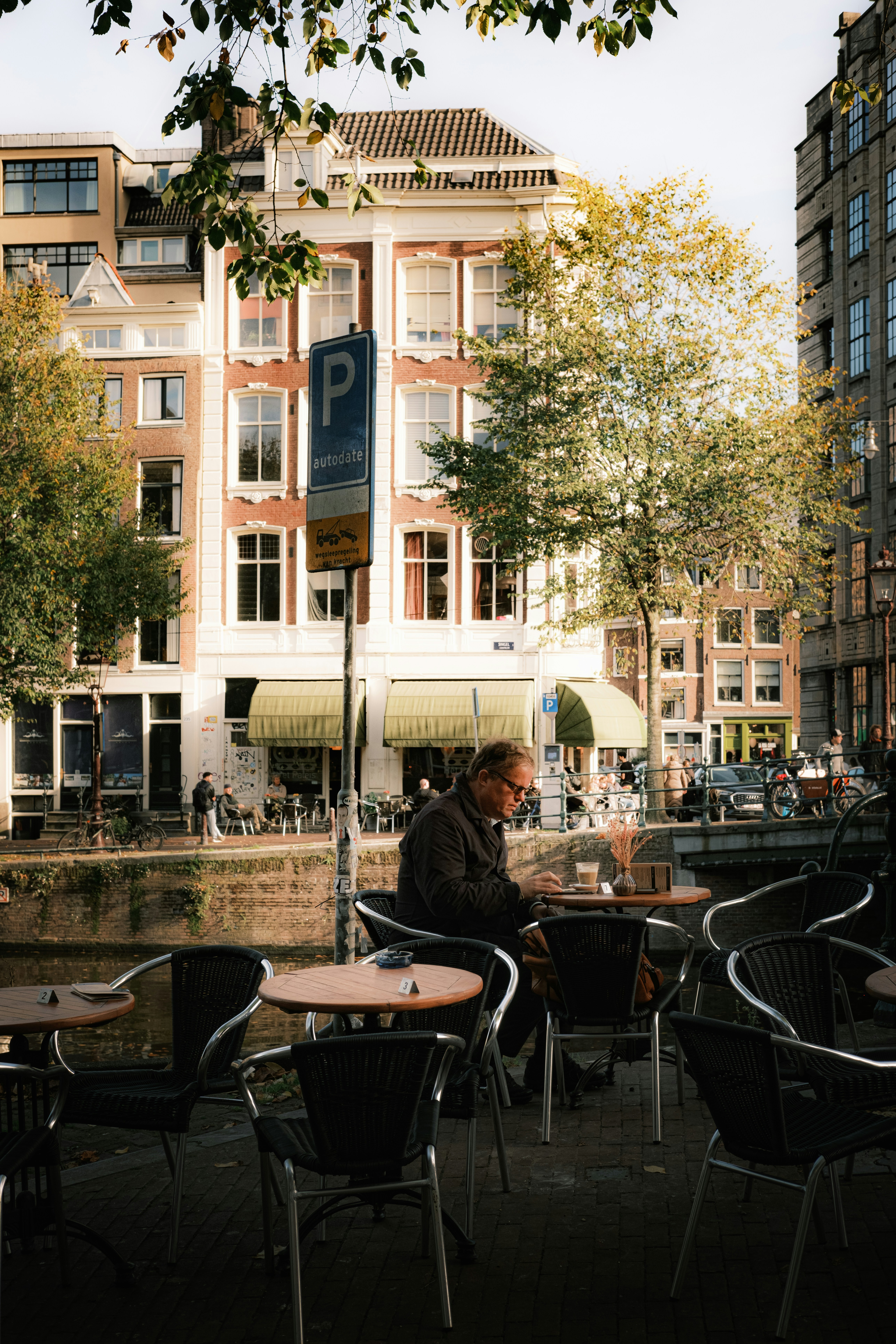 A man sitting at a table in front of a building