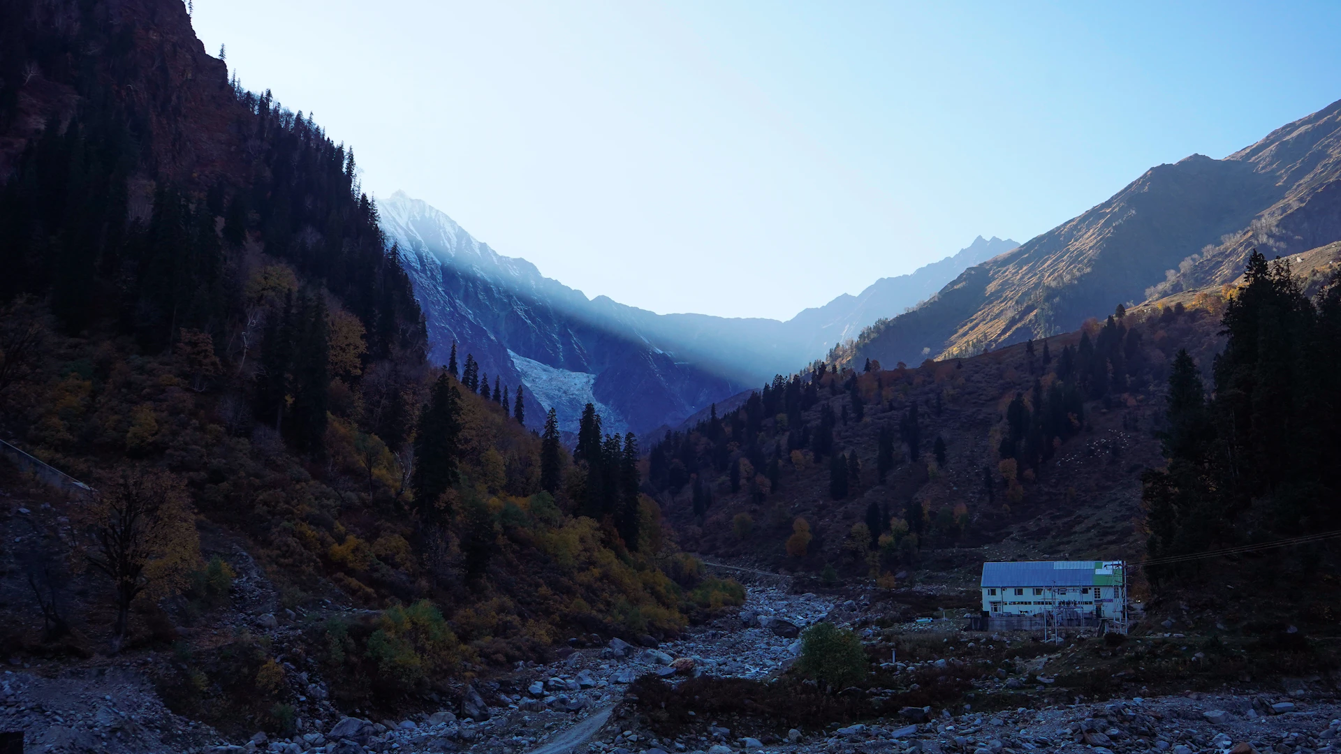 A view of a valley with mountains in the background