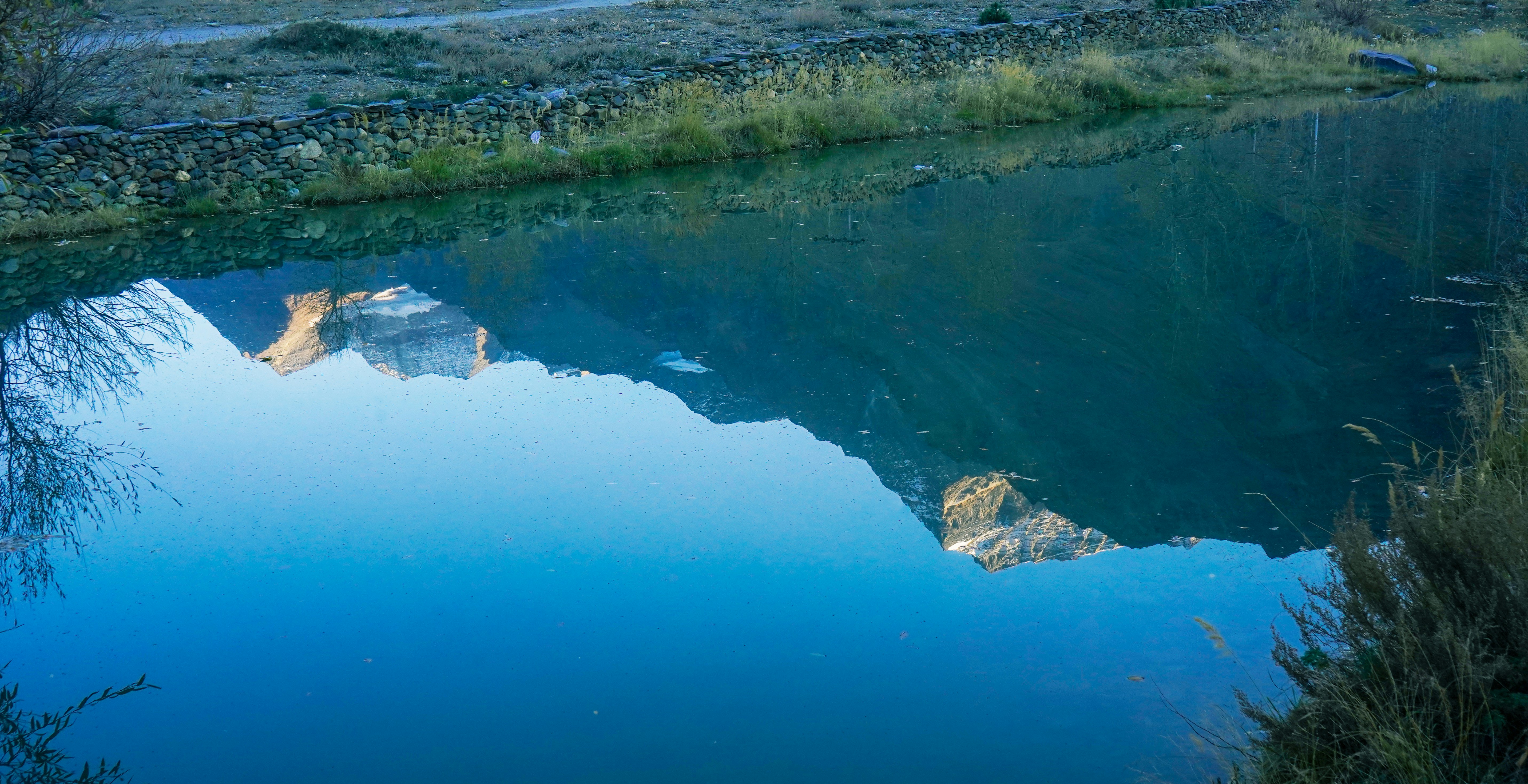 A lake with a mountain in the background